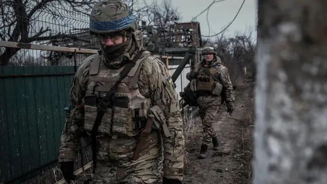 epa10507972 Ukrainian soldiers from the Volyn Detachment patrol the devastated town of Velyka Novosilka, Donetsk region, Ukraine, 07 March 2023. There are less than 500 people still living in the town, because the Russian positions are less than a kilometer away and the shelling is continuous. Russian troops entered Ukrainian territory on 24 February 2022, starting a conflict that has provoked destruction and a humanitarian crisis. EPA/MARIASENOVILLA