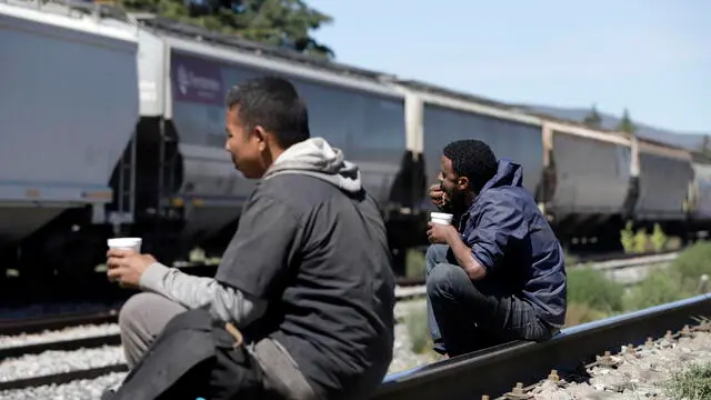 epa10926461 Central American migrants rest on the train tracks in the community of Jeses Nazareno, municipality of Serdan City, State of Puebla, Mexico, 18 October 2023. Migrants traveling aboard "The Beast"?, a long freight train, has increased by 60 percent in the last four weeks in Puebla, the Mexican Red Cross revealed, despite attemps by the Mexican Government to stop it. EPA/Hilda Rios