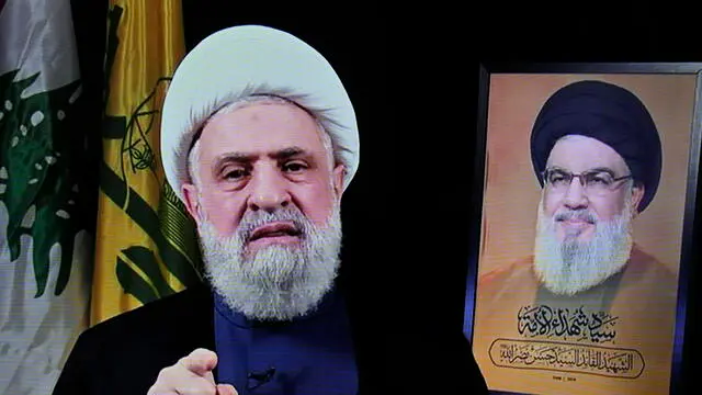 epa11692455 A photo of a screen shows Hezbollah's new leader Sheikh Naim Qassem (L) delivering a televised speech broadcasted on Hezbollah's al-Manar TV channel, in Beirut, Lebanon, 30 October 2024. Lebanon's Hezbollah on 29 October announced that its deputy leader Naim Qassem was appointed to succeed late chief Hassan Nasrallah (R). EPA/WAEL HAMZEH