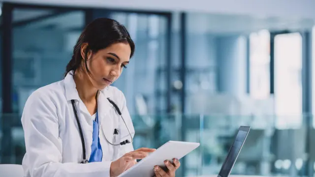 Shot of a young doctor using a digital tablet in a hospital