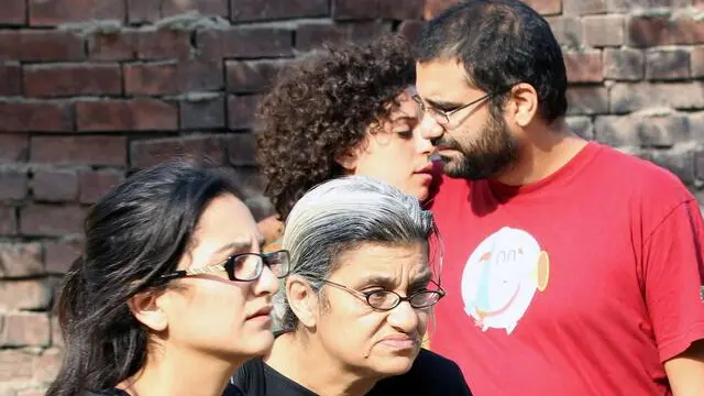 epa04464588 Egyptian activist and blogger Alaa Abdel-Fattah (R) his mother Laila Soueif (C) and his sister Mona Abdel-Fattah (L) react after hearing a court sentence against Abdel-Fattah's sister, Sanaa Saif al-Islam, outside a court in Cairo, Egypt, 26 October 2014. An Egyptian court sentenced 23 pro-democracy campaigners to three years in prison and fined each of the defendants with 10,000 Egyptian pounds (1,400 dollars) for holding an unauthorized protest. The activists were also charged with rioting, illegally possessing weapons and damaging property during a demonstration they held near the presidential palace in July against a law heavily restricting public rallies. EPA/KHALED ELFIQI