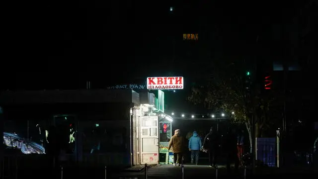 epa11727885 People walk in a residential area in the dark during a scheduled power cut in Kyiv, Ukraine, 18 November 2024, amid the Russian invasion. Ukraine's national power supply Ukrenergo announced on 18 November, that power cuts have been applied throughout the country due to emergency shutdown of units at several power plants as a result of waves of Russian missile attacks on the energy infrastructure. Russian forces launched a large-scale attack across Ukraine on 17 November, with around 120 missiles and 90 unmanned aerial vehicles (UAVs). The main targets of the attack were Ukraine's energy infrastructure, Ukrainian President Zelensky said. Russian troops entered Ukrainian territory on 24 February 2022, starting a conflict that has provoked destruction and a humanitarian crisis. EPA/SERGEY DOLZHENKO