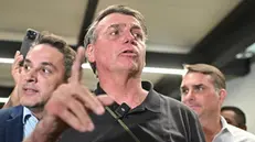 epa11740682 Brazil's former President Jair Bolsonaro speaks during a press conference as he leaves Juscelino Kubitschek International Airport in Brasilia, Brazil, 25 November 2024. EPA/Andre Borges