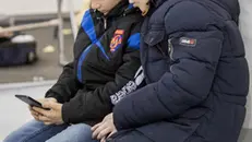 epa07411446 Children are watching their mobile phones while are waiting their mothers, during the professional exhibition 'Beauty 2019' held at the MoldExpo International Exhibition Centre in Chisinau, Moldova, 03 March 2019. EPA/DUMITRU DORU