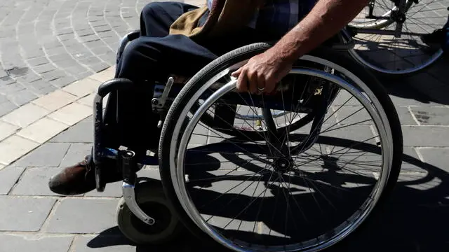 epa09617108 A disabled Yemeni rides a wheelchair on the eve of the International Day of Persons with Disabilities, at a street in Sanaâ€™a, Yemen, 02 December 2021. Approximately three million people with disabilities live in war-ridden Yemen, UNICEF has estimated. The International Day of People with Disability, inaugurated by the United Nations in 1992, is annually observed on 03 December around the world to mobilize support for rights and well-being of persons with disabilities in all spheres of society and development. EPA/YAHYA ARHAB