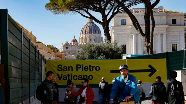 Tourists around the construction site fencing at Piazza Pia, which is part of the preparations for the Jubilee Year of 2025 in Rome, Italy, 15 November 2024. The Jubilee, referred to as the Holy Year, is an occasion in the Catholic Church that generally takes place every 25 years. The jubilee year will begin on 24 December 2024. ANSA/FABIO FRUSTACI