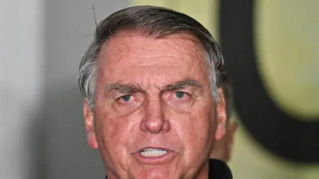 epa11740681 Brazil's former President Jair Bolsonaro speaks during a press conference as he leaves Juscelino Kubitschek International Airport in Brasilia, Brazil, 25 November 2024. EPA/Andre Borges