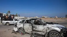 epa11749057 Palestinians inspect a destroyed vehicle on Salah al-Din Road following Israeli military strikes, east of Khan Yunis, southern Gaza Strip, 30 November 2024. At least five people, including three workers from the World Central Kitchen (WCK), were killed in Israeli military strikes that hit a civilian car, according to medics at Nasser Hospital. Israel's military stated on 30 November, that earlier in the day it struck a 'civilian unmarked vehicle' whose movement on the route was not coordinated for transporting of aid. According to the Israeli statement, the target of the strike was an individual alleged of taking part in the 07 October 2023 attacks. More than 44,300 Palestinians and over 1,400 Israelis have been killed, according to the Palestinian Health Ministry and the Israeli Army, since Hamas militants launched an attack against Israel from the Gaza Strip on 07 October 2023, and the Israeli operations in Gaza and the West Bank which followed it. EPA/HAITHAM IMAD