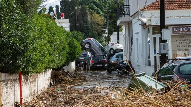 epa11751466 Cars piled up on a road following the passage of storm bora in Ialyssos, Rhodes, Greece, 01 December 2024. The island of Rhodes has been in a state of emergency for the last few hours as the bad weather from storm Bora is still ongoing. The road network in the municipal units of Ialyssos and Kallithea has been damaged. Kindergartens, elementary schools, high schools, and high schools in Rhodes will be closed on 02 December 2024. EPA/LEFTERIS DAMIANIDIS