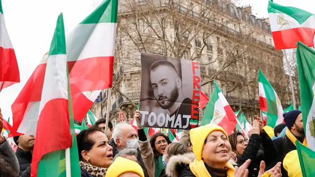 epa10463068 A woman holds a portrait of Iranian hip hop artist Toomaj Salehi, one of the main voices of the Iranian revolution, during a demonstration on the 44th anniversary of the Iranian revolution against Shahh Reza Pahlavi, in Paris, France, 12 February 2023. The protesters rejected the Shah's dictatorshipin the then Imperial State of Iran from 16 September 1941 until he was overthrown in the Iranian Revolution on 11 February 1979, and the following mullahs' theocracy and called for a democratic and secular government in Iran. EPA/TERESA SUAREZ