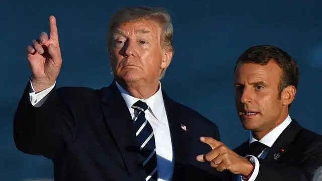 epa07795592 US President Donald Trump (L) and France's President Emmanuel Macron (R) gesture after the family photograph during the G7 summit in Biarritz, France, 25 August 2019 (isued 26 August 2019). The G7 Summit runs from 24 to 26 August in Biarritz. EPA/MICK TSIKAS AUSTRALIA AND NEW ZEALAND OUT