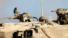 epa11714281 Israeli soldiers stand guard atop a tank while patrolling the border gate during the passing of a World Food Programme (WFP) aid convoy (not pictured) through the Erez crossing, on the border with the northern Gaza Strip, in southern Israel, 11 November 2024. According to the Israeli Army (Tsahal) and Coordination of Government Activities in the Territories (COGAT), 40 World Food Programme (WFP) aid trucks crossed into the northern Gaza Strip from Israel. According to the United Nations over 1.8 million people in Gaza face extreme hunger. EPA/VASSIL DONEV