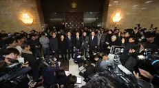 epa11754810 Floor leader of the main opposition Democratic Party Park Chan-dae (C) announces his stance at the National Assembly in Seoul shortly after an emergency plenary session of National Assembly passed a resolution urging the president to withdraw martial law in Seoul, South Korea, early 04 December 2024. President Yoon Suk Yeol had declared martial law on 03 December night, citing the need to root out pro-North Korean forces and uphold the constitutional order. EPA/YONHAP SOUTH KOREA OUT