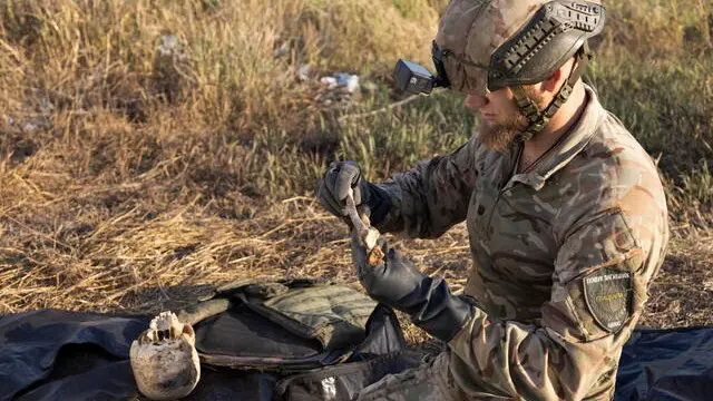 epa11517595 Members of Ukraineâ€™s 'Platsdarm' search group work on exhuming and identifying the bodies of dead Russian servicemen near a frontline in the Bakhmut area, Donetsk region, Ukraine, 01 August 2024 (issued 02 August 2024), amid the Russian invasion. The 'Platsdarm' group searches for the bodies of Russian soldiers, documenting and collecting clues that would allow IDing them, and hand them over to the Russian side in exchange for Ukrainian soldiers' bodies. EPA/NIKOLETTA STOYANOVA