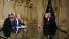 epa11755283 France's Prime Minister Michel Barnier (R) delivers remarks during a televised interview broadcast by news anchors Gilles Bouleau (C) and Anne-Sophie Lapix, on the evening news on French TV channels, at Hotel Matignon in Paris, France, 03 December 2024. Opposition lawmakers vowed to topple the minority government of Barnier in a no-confidence vote after just three months in office. EPA/THOMAS SAMSON / POOL MAXPPP OUT