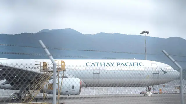 epa11584598 A Cathay Pacific Airways jetliner parks at Hong Kong International Airport, in Hong Kong, China, 04 September 2024. Cathay Pacific has cancelled and grounded planes for inspection after detecting an engine problem in one of them. EPA/BERTHA WANG PICTURE TAKEN THROUGH A FENCE