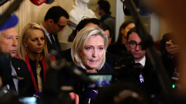 epaselect epa11753420 Party leader of Rassemblement National (RN) Marine Le Pen (C) talks to journalists after the French National Assembly debate on parts of France's 2025 budget bill, in Paris, France, 02 December 2024. French Prime Minister Barnier activated Article 49.3 of the Constitution to pass his social security budget bill without a vote, as a majority of members of Parliament rejected his project on 02 December 2024. EPA/MOHAMMED BADRA