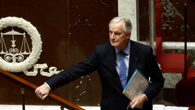 epa11757052 French Prime Minister Michel Barnier leaves the rostrum after delivering a speech during a no-confidence vote against his government at the National Assembly, in Paris, France, 04 December 2024. The no-confidence vote comes after the French prime minister activated Article 49.3 of the Constitution to pass his social security budget bill without a vote, as a majority of members of Parliament rejected his project on 02 December 2024. EPA/YOAN VALAT