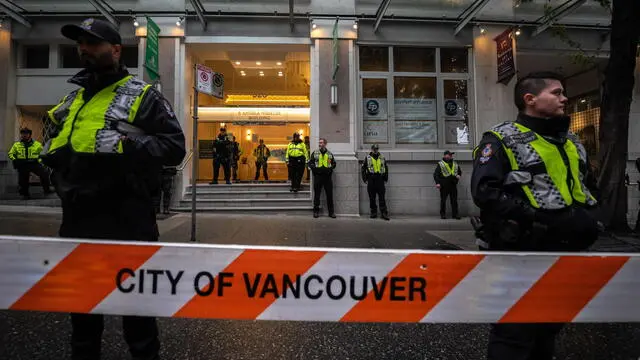 epa10883122 Vancouver Police stand guard during a protest for justice for Hardeep Singh Nijjar, a Sikh leader who was shot and killed earlier this year, at the Consulate General of India in Vancouver, British Columbia, Canada, on 25 September 2023. Earlier this week Canadian Prime Minister Justin Trudeau accused agents of the government of India of carrying out the killing of Nijjar in June, an accusation that has raised diplomatic tensions between the two countries. EPA/ETHAN CAIRNS