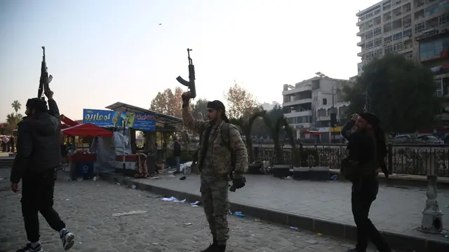 epa11760243 Opposition fighters fire their guns in the air in celebration after they entered the city of Hama, Syria, 06 December 2024. Syrian opposition forces, led by the Islamist militant group Hayat Tahrir al-Sham (HTS), launched an offensive on 27 November, triggering counterattacks by the Syrian regime forces as well as Russian and Syrian airstrikes on opposition-controlled areas. According to Hay'at Tahrir Al-Sham leader Abu Mohammad Al-Jolani, there will be 'no revenge' after opposition groups entered the strategically important Syrian city of Hama on 05 December. EPA/BILAL AL HAMMOUD