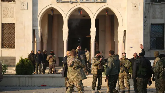 epaselect epa11760242 Opposition fighters fire their guns in the air in celebration in front of a Syrian government building after they entered the city of Hama, Syria, 06 December 2024. Syrian opposition forces, led by the Islamist militant group Hayat Tahrir al-Sham (HTS), launched an offensive on 27 November, triggering counterattacks by the Syrian regime forces as well as Russian and Syrian airstrikes on opposition-controlled areas. According to Hay'at Tahrir Al-Sham leader Abu Mohammad Al-Jolani, there will be 'no revenge' after opposition groups entered the strategically important Syrian city of Hama on 05 December. EPA/BILAL AL HAMMOUD