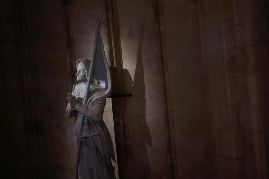 epa11764455 View of a marble Statue of Saint Joan of Arc by Charles Desvergnes (1920) during the inaugural Mass, with the consecration of the high altar, at the Notre-Dame de Paris Cathedral in Paris, France, 08 December 2024. The Notre Dame de Paris Cathedral reopened on 07 December after nearly six years of renovation work following its destruction by a fire on 15 April 2019. EPA/SARAH MEYSSONNIER / POOL MAXPPP OUT