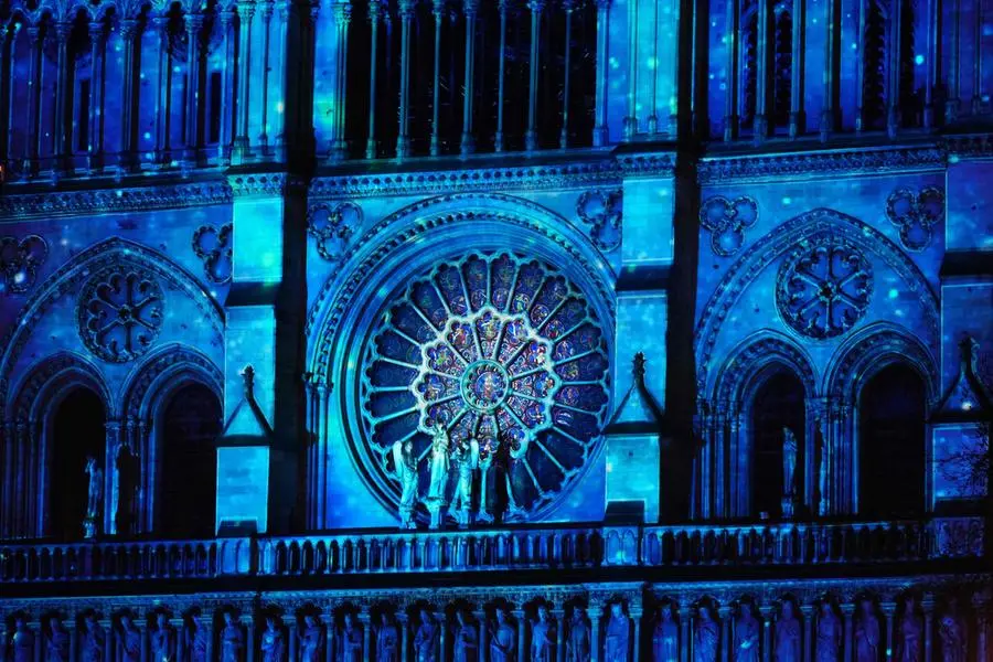 This photograph shows Notre-Dame Cathedral illuminated during a ceremony to mark the re-opening of the landmark Cathedral, in central Paris, on December 7, 2024. Around 50 heads of state and government are expected in the French capital to attend the ceremony marking the rebuilding of the Gothic masterpiece five years after the 2019 fire which ravaged the world heritage landmark and toppled its spire. Some 250 companies and hundreds of experts were part of the five-year restoration project at a cost of hundreds of millions of euros. (Photo by Dimitar DILKOFF / AFP)