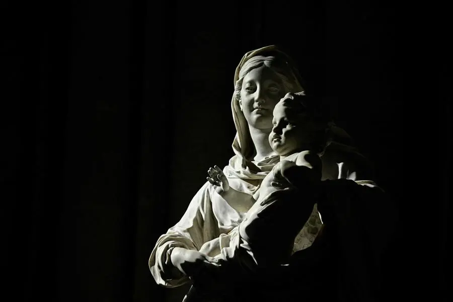 This photograph shows an sculpture of the Virgin Mary holdin the baby Jesus during prayers for the consecration of the Notre-Dame de Paris new main altar, designed by French artist and designer Guillaume Bardet which replaces the old one that was destroyed in 2019, during a mass at the Notre-Dame de Paris cathedral, in Paris on December 8, 2024. Newly restored Notre Dame cathedral is set to hold its first service for the public on December 8, 2024 after a historic re-opening ceremony that saw firefighters, builders and artists celebrated for their work saving the 12th-century masterpiece. The beloved Paris monument nearly burned down in 2019, but has been renovated inside and fitted with a new roof and spire during a frenzied reconstruction effort since then. (Photo by JULIEN DE ROSA / AFP) / RESTRICTED TO EDITORIAL USE - MANDATORY MENTION OF THE ARTIST UPON PUBLICATION - TO ILLUSTRATE THE EVENT AS SPECIFIED IN THE CAPTION