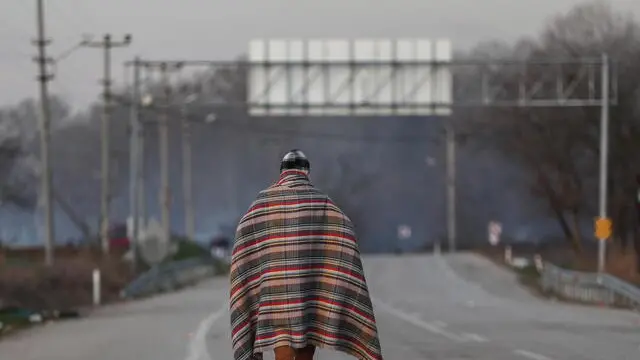 epa08268886 A refugee walks to Pazarkule Border gate early in the morning at the Turkish-Greek border, in Edirne, Turkey, 04 March 2020. More than 10,000 migrants, mostly from Syria, have reached Turkey's land borders with EU's states Greece and Bulgaria since Ankara said on 27 February 2020 it would stop keeping them on its territory. Turkey's announcement came amid a Russian-backed Syrian government offensive into Syria's northwestern Idlib province, where Turkish troops are fighting killing dozens of Turkish troops. EPA/SEDAT SUNA