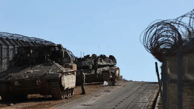 epaselect epa11766108 Israeli troops at the border with Syria near the Druze village of Majdal Shams, in the Israeli-annexed Golan Heights, 09 December 2024. The Israeli army announced it has deployed forces to strengthen the defense of the Golan Heights and the eastern Israeli border with Syria. Syrian rebels entered Damascus on 08 December 2024 and announced in a televised statement the 'Liberation of the city of Damascus and the overthrow of Bashar al-Assad', as well as the release of all the prisoners. EPA/ATEF SAFADI
