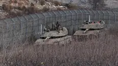 epa11768780 Israeli tanks at the security fence between Israel and Syria, near the Druze village of Majdal Shams, in the Israeli-annexed Golan Heights, 10 December 2024. Israel's military said that paratroopers' forces, joined by other troops, are conducting 'defense activities' to prevent 'any threat' and are deployed in key positions within the buffer zone. EPA/ATEF SAFADI