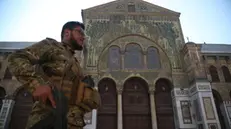 epaselect epa11766260 An armed rebel walks in the Umayyad Mosque in Damascus, Syria, 09 December 2024. Syrian rebels entered Damascus on 08 December 2024 and announced in a televised statement the 'Liberation of the city of Damascus and the overthrow of Bashar al-Assad', as well as the release of all the prisoners. EPA/BILAL ALHAMMOUD