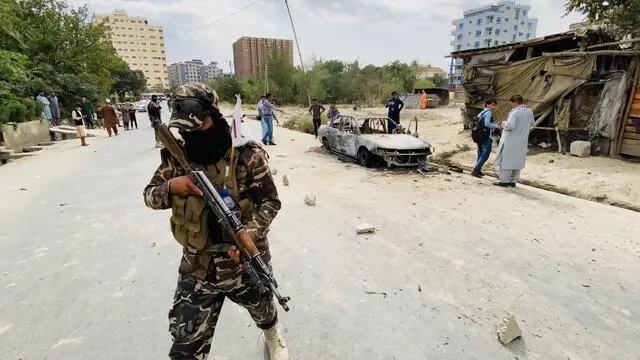 epa09436394 Taliban stands guard near a vehicle which was used to fire rockets at the Hamid Karzai International Airport in Kabul, Afghanistan, 30 August 2021. Multiple rockets fired from a car landed near the Kabul airport on 30 August. The process of withdrawing the 5,000 United States military personnel deployed to Kabul's airport for the evacuation of Americans and Afghan allies is under way in the face of "very real" threats of additional attacks such as the one two days ago that left some 200 people dead, the Pentagon said 28 August. More than 117,000 people have departed from the Kabul airport since the "massive military, diplomatic, security and humanitarian undertaking" began following the fall of the capital under Taliban's rule on 15 August. EPA/STRINGER