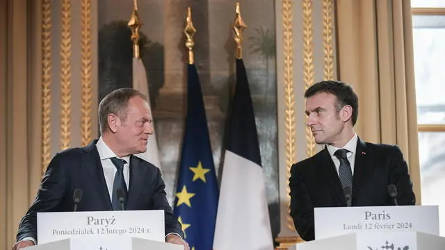 epa11147485 French President Emmanuel Macron (R) and Polish Prime Minister Donald Tusk (L) deliver statements to the media as part of their meeting at Elysee palace in Paris, France, 12 February 2024. Polish Prime Minister Tusk met with the French President and then will travel to Berlin to meet with the German Chancellor. Paris and Berlin are among the first European capitals Tusk will visit since taking office. EPA/MARCIN OBARA POLAND OUT