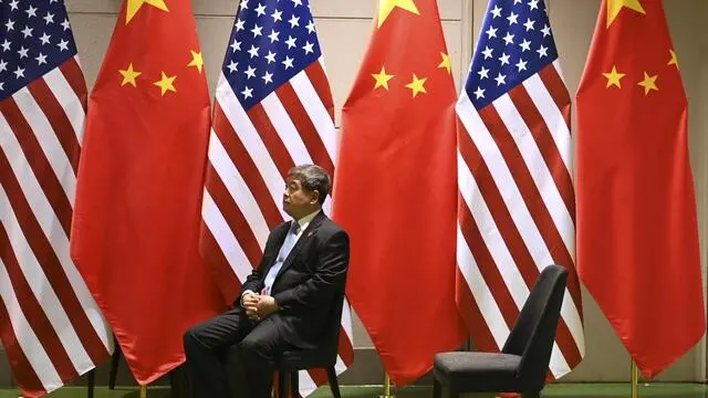 epa07681581 A Chinese official waits on a chair in the corridors outside a bilateral meeting between Chinese President Xi Jingping and US President Donald Trump during the second day of the summit in Osaka, Japan, 29 June 2019. It is the first time Japan will host a summit. The summit gathers leaders from 19 countries and the European Union to discuss topics such as global economy, trade and investment, innovation and employment. EPA/LUKAS COCH AUSTRALIA AND NEW ZEALAND OUT