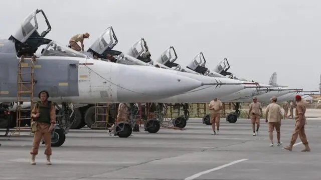 epa05289989 Russian technicians maintain Su-24 bomber at Hmeimym airbase in Latakia province, Syria, 04 May 2016. Hmeimym airbase serves as the base of operation for the Russian air force in Syria. The United States and Russia have agreed to extend the cease-fire in Syria to the city of Aleppo, the US State Department reported on 04 May. EPA/SERGEI CHIRIKOV