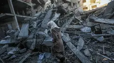 epaselect epa11774221 A Palestinian woman walks among the rubble of destroyed buildings following Israeli airstrikes in Al Nuseirat refugee camp, central Gaza Strip, 13 December 2024. According to the Palestinian Ministry of Health in Gaza, at least 40 Palestinians were killed in an overnight Israeli airstrike in Al Nusairat refugee camp, central Gaza. More than 45,500 Palestinians and over 1,400 Israelis have been killed, according to the Palestinian Health Ministry and the Israeli Army, since Hamas militants launched an attack against Israel from the Gaza Strip on 07 October 2023 and the Israeli operations in Gaza and the West Bank that followed it. EPA/MOHAMMED SABER