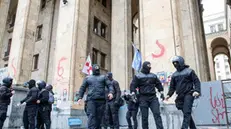 epa11339737 Georgian policemen guard during a rally against a draft bill on 'foreign agents' in front of the Parliament building in Tbilisi, Georgia, 14 May 2024. The draft bill on 'foreign agents' was adopted in Georgia in the final third reading. A total of 84 deputies voted for, and 30 against. The law will be sent to the Georgian President Salome Zourabichvili for signing, who has vowed to veto it. EPA/DAVID MDZINARISHVILI