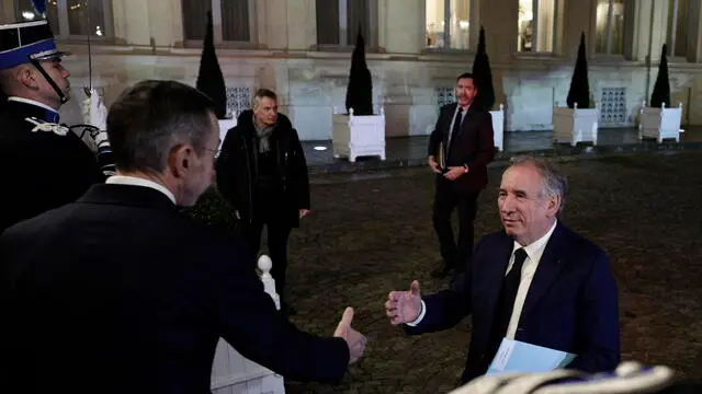 epa11777300 French outgoing Interior Minister Bruno Retailleau (L) greets French Prime Minister Francois Bayrou (R) as he arrives at the Interior Ministry Crisis Centre for a meeting about the situation in Mayotte devastated by the tropical cyclone Chido, in Paris, France, 14 December 2024. EPA/STEPHANE DE SAKUTIN / POOL MAXPPP OUT