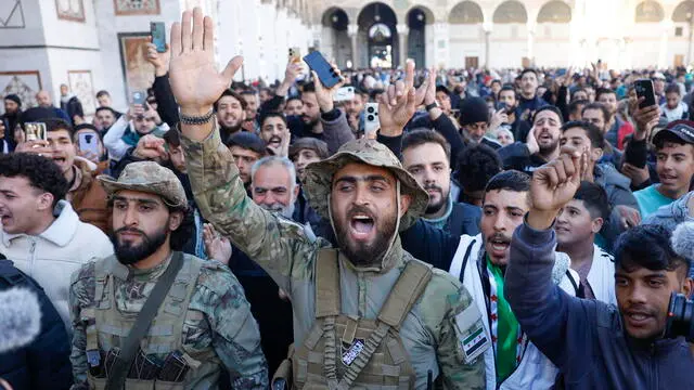 epa11775579 People celebrate inside the Umayyad Mosque, following the overthrow of President Bashar al-Assad by opposition rebels, in Damascus, Syria, 13 December 2024. Hay'at Tahrir Al-Sham (HTS) leader Abu Mohammad Al-Jolani called on people across the country to celebrate 'the victory of the revolution' on 13 December, following the capture of Damascus and the overthrow of Bashar al-Assad on 08 December 2024. EPA/ANTÃ“NIO PEDRO SANTOS