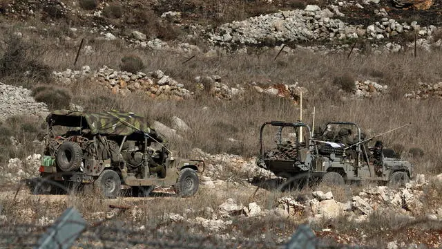 epa11778249 Israeli troops are seen on the Syrian side of the border between Israel and Syria, near the Druze village of Majdal Shams, in the Israeli-annexed Golan Heights, 15 December 2024. Israel's military announced on 10 December that paratroopers' forces, joined by other troops, are conducting 'defense activities' to prevent 'any threat' and are deployed in key positions within the buffer zone. EPA/ATEF SAFADI