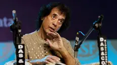 epa11035407 Indian Tabla maestro, musical producer, film actor and composer Ustad Zakir Hussain performs during the Swara Samrat Festival in Kolkata, India, 17 December 2023. The festival runs from 15 to 17 December. EPA/PIYAL ADHIKARY