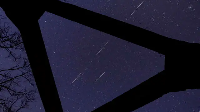epa08372363 A computer-generated image from several long-exposure images shows Starlink satellites in the sky above the concrete base of a former heating plant in Salgotarjan, Hungary, 20 April 2020. Movement of satellites are seen as shining tracks. The Starlink programme is a global satellite project of the American rocket company SpaceX to provide worldwilde internet service. EPA/PETER KOMKA HUNGARY OUT