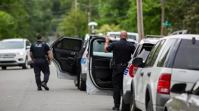 epa11310878 Police officers leave the area near a partially-destroyed house at 5525 Galway Drive in the aftermath of a shooting which left four law enforcement officers dead in Charlotte, North Carolina, USA, 30 April 2024. Four law enforcement officers were killed and four others injured when members of the US Marshals Fugitive Task Force attempted to serve a warrant on Terry Clark Hughes Jr on 29 April 2024. Hughes was also killed in the incident according to the Charlotte-Mecklenburg Police Department. EPA/VEASEY CONWAY