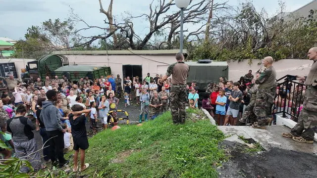 epa11778698 A handout photo made available by the French Army on 15 December 2024 shows soldiers with the local population in the French overseas territory of Mayotte. At least 14 people were killed and more than 200 injured after tropical cyclone Chido battered the French Indian Ocean territory of Mayotte on 14 December, authorities said. EPA/ETAT-MAJOR DES ARMEE HANDOUT -- BEST QUALITY AVAILABLE -- MANDATORY CREDIT: ETAT-MAJOR DES ARMEE -- HANDOUT EDITORIAL USE ONLY/NO SALES