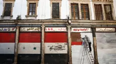 epa11775601 A man paints the railings of his establishment in Damascus, Syria, 13 December 2024. Hay'at Tahrir Al-Sham (HTS) leader Abu Mohammad Al-Jolani called on people across the country to celebrate 'the victory of the revolution' on 13 December, following the capture of Damascus and the overthrow of Bashar al-Assad on 08 December 2024. EPA/ANTÃ“NIO PEDRO SANTOS