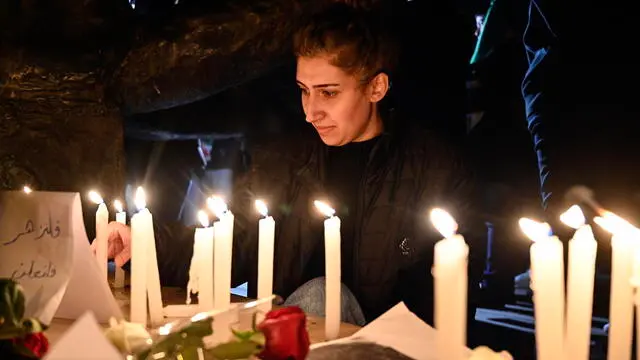 epa11781338 A woman lights candles during a march under the slogan 'From Beirut, freedom, we declare the fall of the Baath regime and criminality' to celebrate the ouster of Syrian President Bashar al-Assad, at Samir Kassir Square in Beirut, Lebanon, 16 December 2024. The march, organized by 'Mada Network and Secular Clubs', was held more than a week after Syrian rebels entered Damascus and announced the overthrow of Bashar al-Assad, and the release of all the prisoners on 08 December 2024. EPA/WAEL HAMZEH