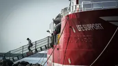 epa11514841 A migrant disembarks following the arrival of the Italian NGO Emergency's Life Support ship, in the port of Naples, southern Italy, 01 August 2024. Italian NGO Emergency's Life Support overnight on 29 July rescued 41 people who were on board a boat in difficulty, in international waters in the Libyan SAR (search and rescue) zone. Italian authorities have assigned Naples as the port of their disembarkation. EPA/CESARE ABBATE