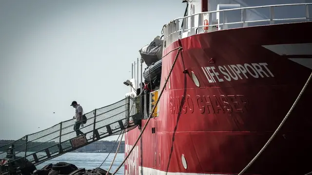 epa11514841 A migrant disembarks following the arrival of the Italian NGO Emergency's Life Support ship, in the port of Naples, southern Italy, 01 August 2024. Italian NGO Emergency's Life Support overnight on 29 July rescued 41 people who were on board a boat in difficulty, in international waters in the Libyan SAR (search and rescue) zone. Italian authorities have assigned Naples as the port of their disembarkation. EPA/CESARE ABBATE