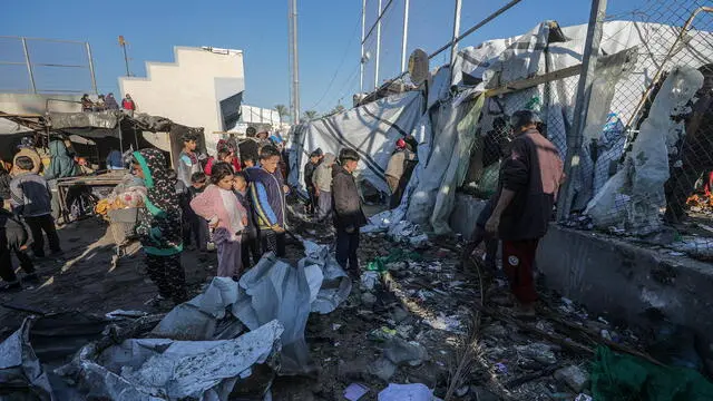 epa11778085 Internally displaced Palestinians inspect destroyed tents inside Al Dura stadium following an Israeli air strike in the west of Deir al-Balah town, central Gaza Strip, 15 December 2024. The Palestinian Ministry of Health in Gaza reported that at least 22 people were killed on December 14 during Israeli airstrikes on the central Gaza Strip. According to the UN, at least 1.9 million people (or nine in ten people) in the Gaza Strip are internally displaced, including people who have been repeatedly displaced. Since October 2023, only about 11 percent of the Gaza Strip has not been placed under Israeli-issued evacuation orders, the UN aid coordination office OCHA said. EPA/MOHAMMED SABER